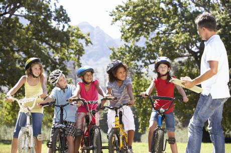 Children Having Bicycle Safety Lesson From Adult