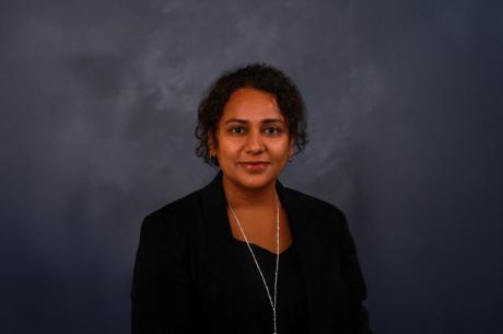 Indian woman with dark hair, black professional attire portrait headshot